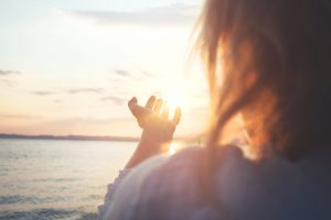 woman try to grab the sun
